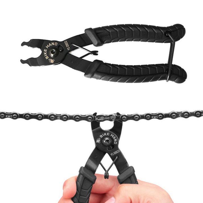 Black chain tool with a hand holding it, on a white background