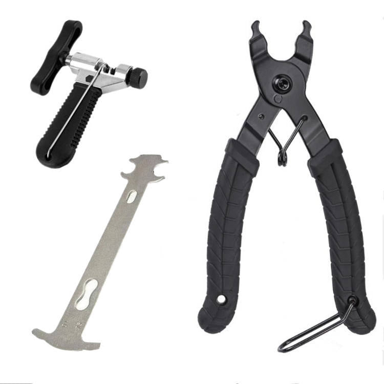 Set of pliers and a metal tool on a white background